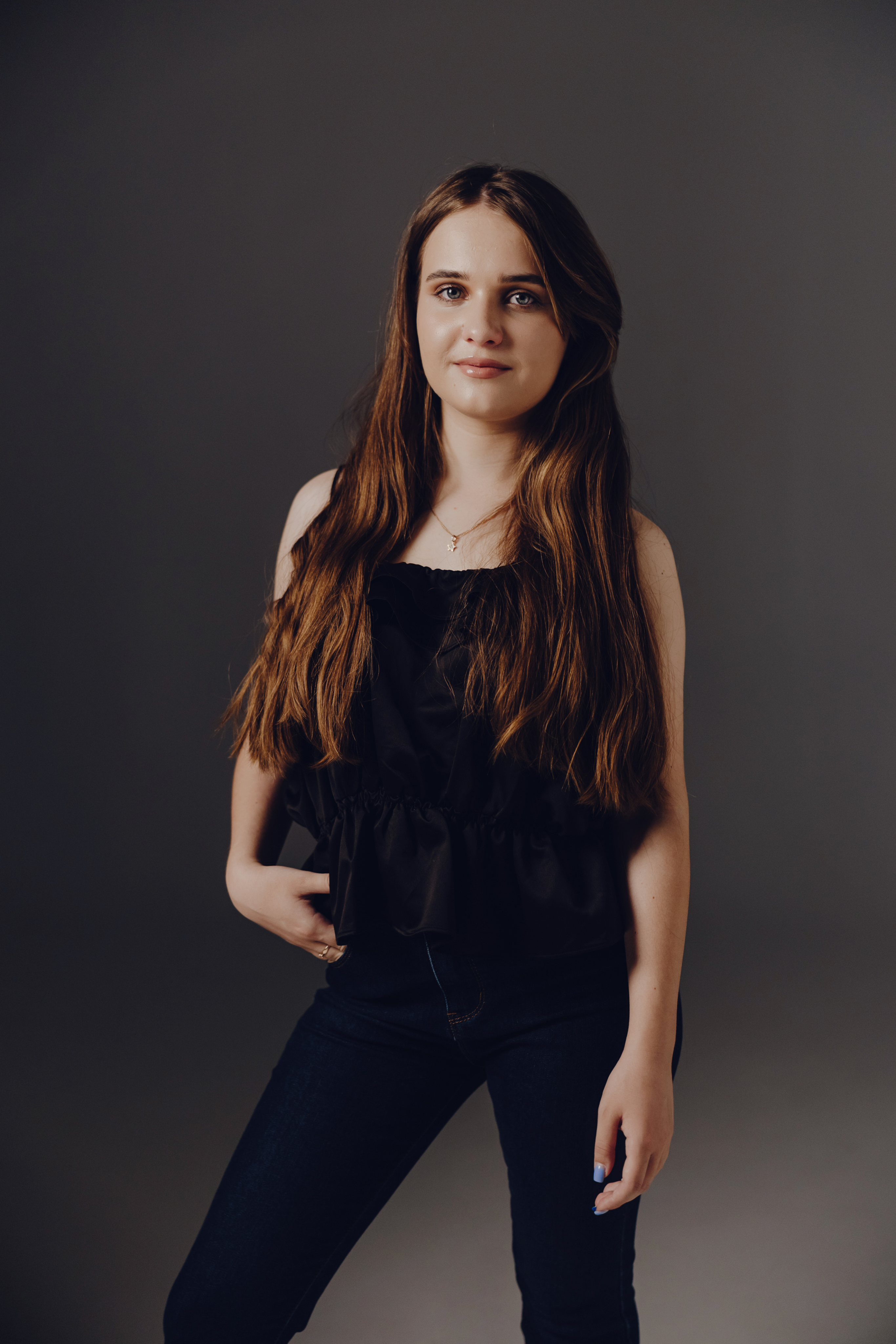 Stylized blue duotone portrait of a woman with long hair facing slightly backward